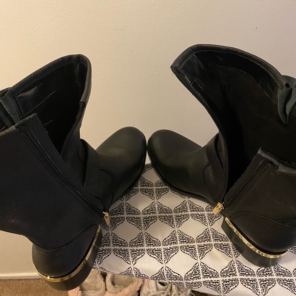 Black Leather Boots with gold buckle detail.